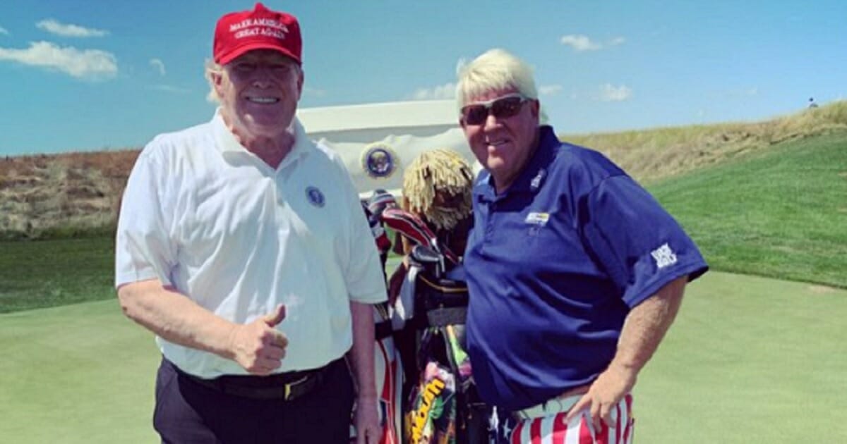 President Donald Trump on the course with golf legend John Daly.