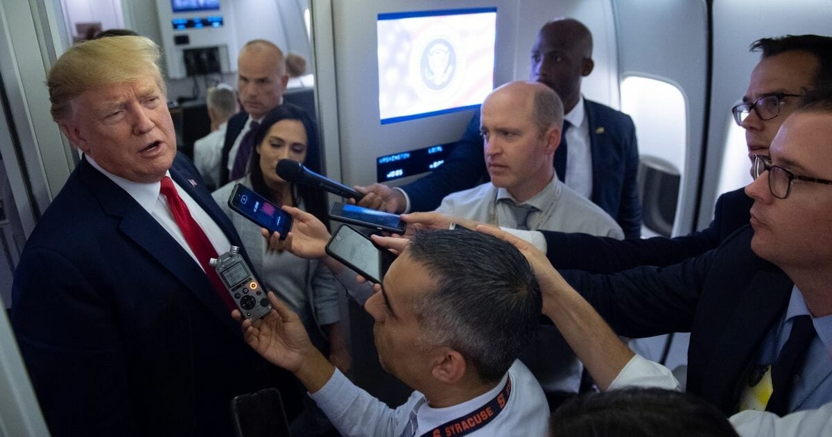 President Donald Trump speaks to the media aboard Air Force One while flying between El Paso, Texas and Joint Base Andrews in Maryland, August 7, 2019.