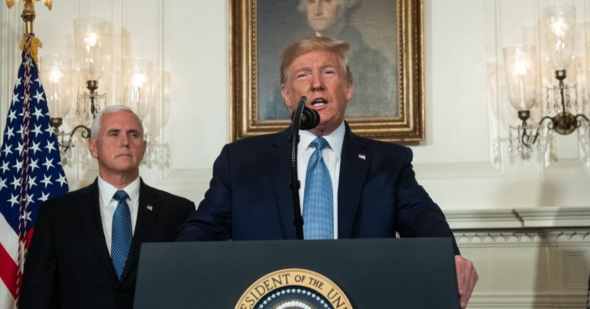 President Donald Trump speaks alongside Vice President Mike Pence about the mass shootings from the Diplomatic Reception Room of the White House in Washington, D.C., Aug. 5, 2019.