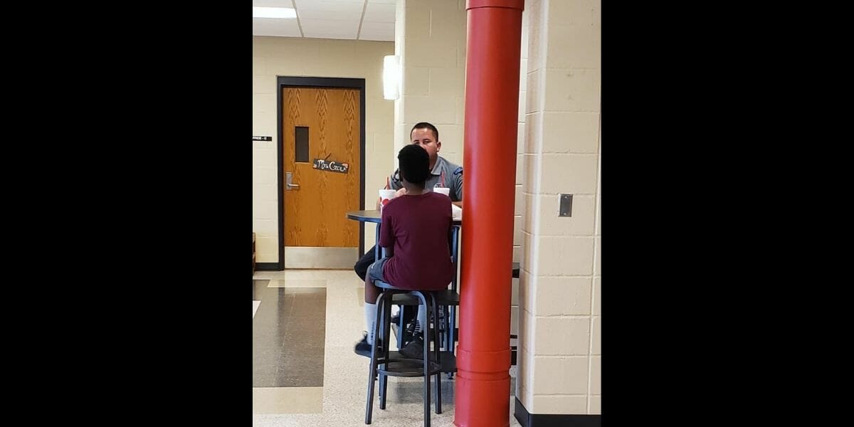 School resource officer Kenny Madden eats lunch with a student