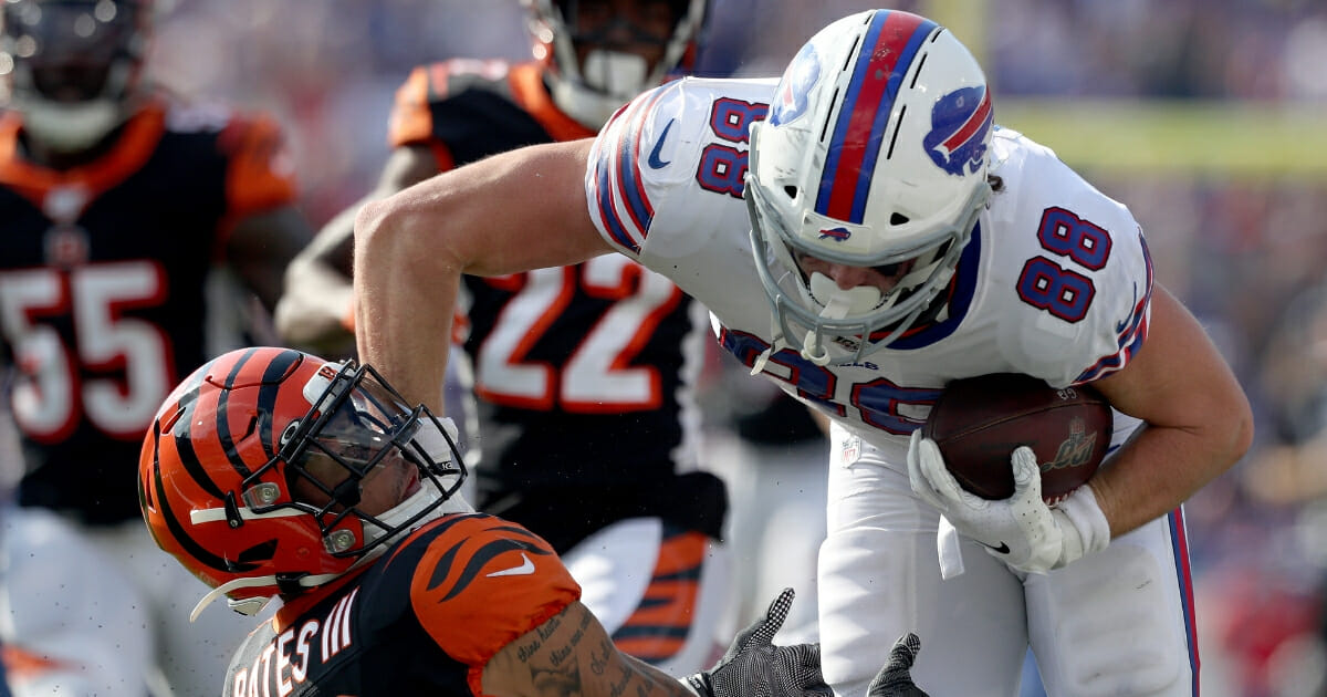 Dawson Knox of the Buffalo Bills runs over Jessie Bates of the Cincinnati Bengals during a game at New Era Field on Sept. 22, 2019.