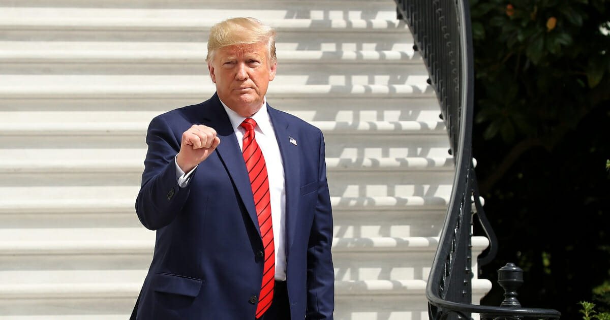 President Donald Trump gestures as he returns to the White House after attending the United Nations General Assembly on Sept. 26, 2019, in Washington, D.C.