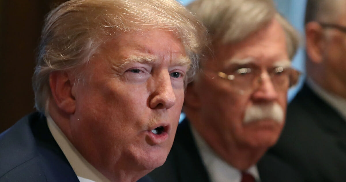President Donald Trump, left, is seen with then-National Security Adviser John Bolton on April 9, 2018, in Washington.