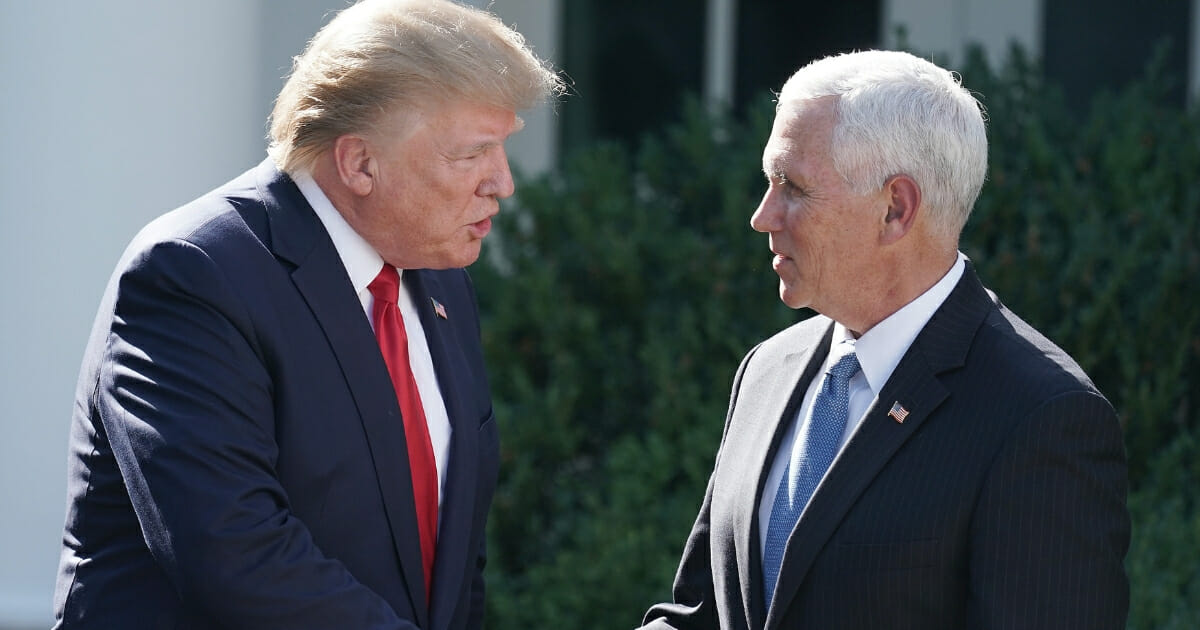 President Donald Trump, left, shakes hands with Vice President Mike Pence during a ceremony marking the establishment of the U.S. Space Command, the sixth national armed service, in the Rose Garden at the White House on Aug. 29, 2019.