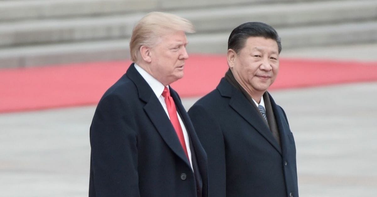 China's President Xi Jinping (R) and U.S. President Donald Trump attend a welcome ceremony at the Great Hall of the People in Beijing on Nov. 9, 2017.