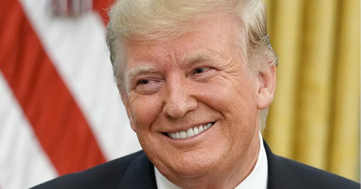 President Donald Trump smiles.