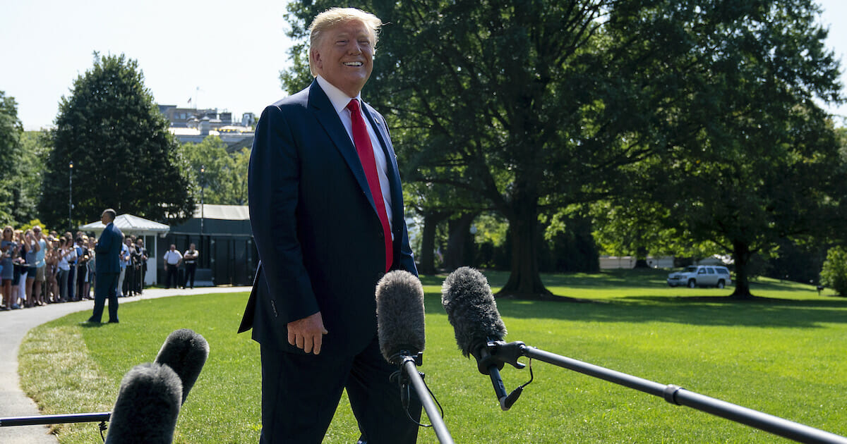 President Donald Trump speaks to members of the media before departing from the White House on the south lawn before he boards Marine One on August 09, 2019 in Washington, D.C.