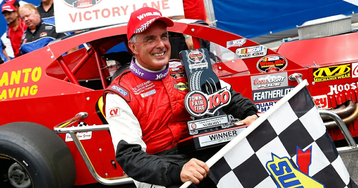Mike Stefanik celebrates in Victory Lane after winning the NASCAR Whelen Modified Tour Town Fair Tire 100 at New Hampshire Motor Speedway on July 14, 2012.