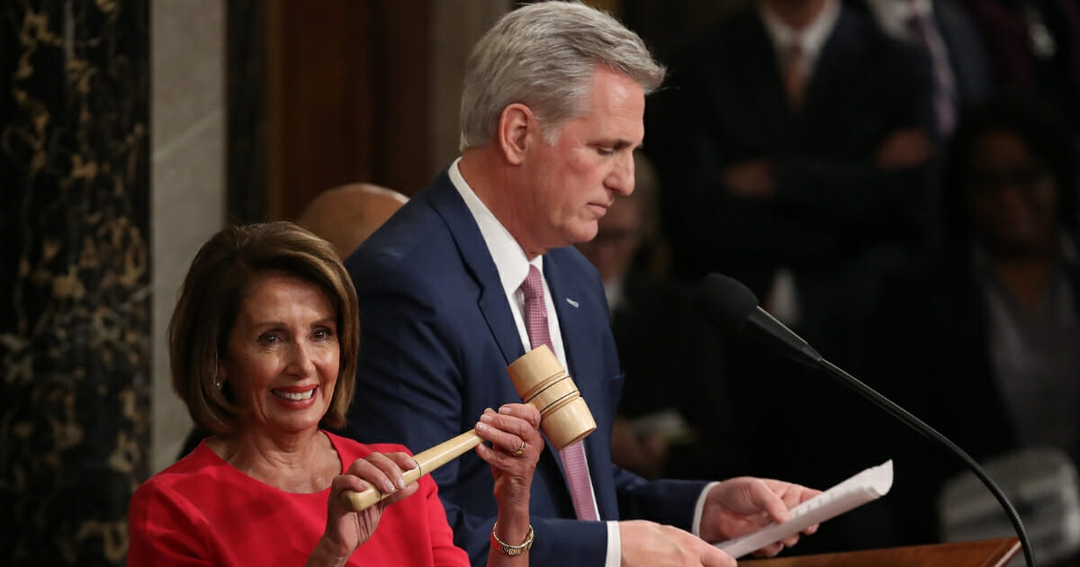 Democratic Rep. Nancy Pelosi smiles after receiving the House speaker's gavel from fellow Californian Kevin McCarthy.