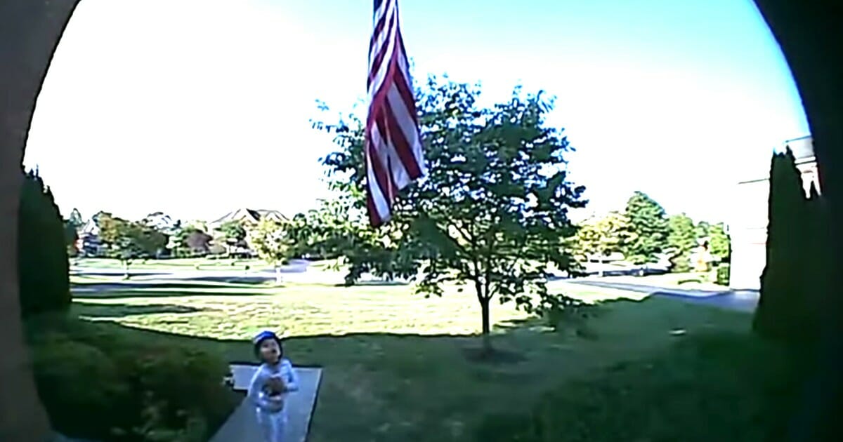 Preston Satterthwaithe recites the Pledge of Allegiance in front of the American flag.