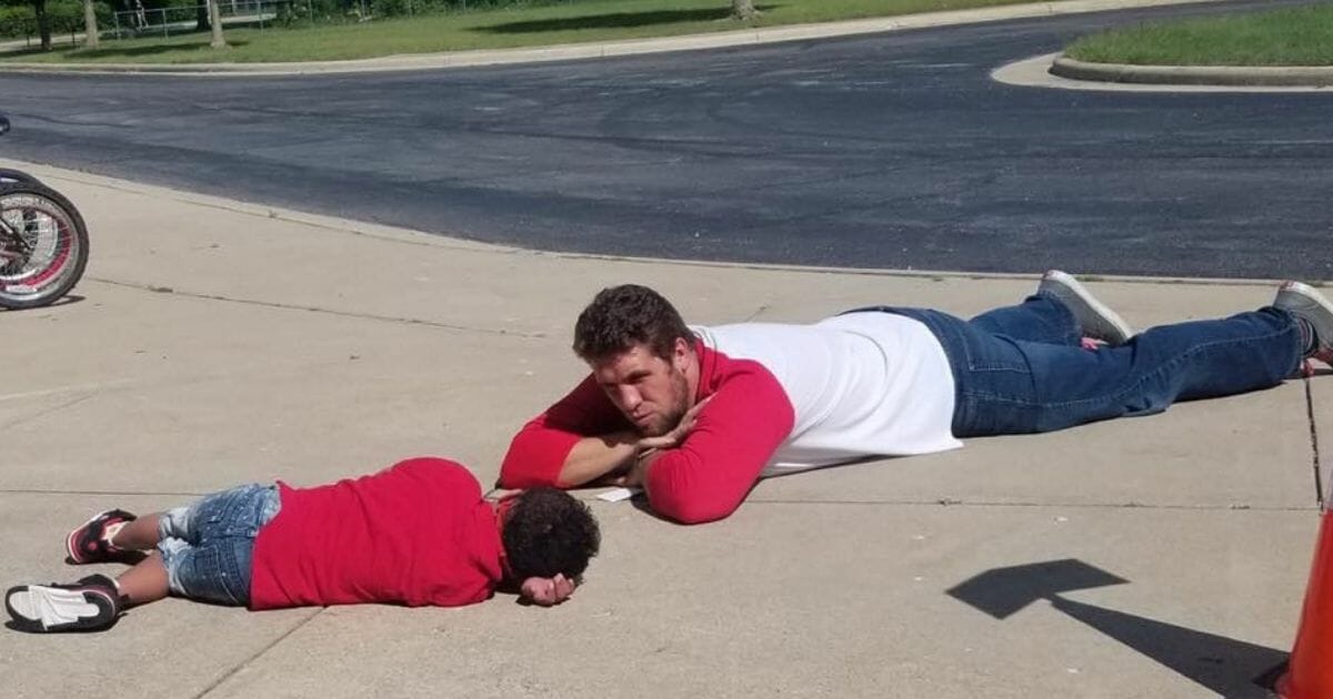 Mr. Smith and his student lying on the ground
