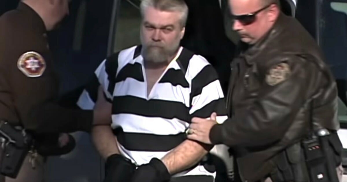 Convicted killer Steven Avery is led by police officers.