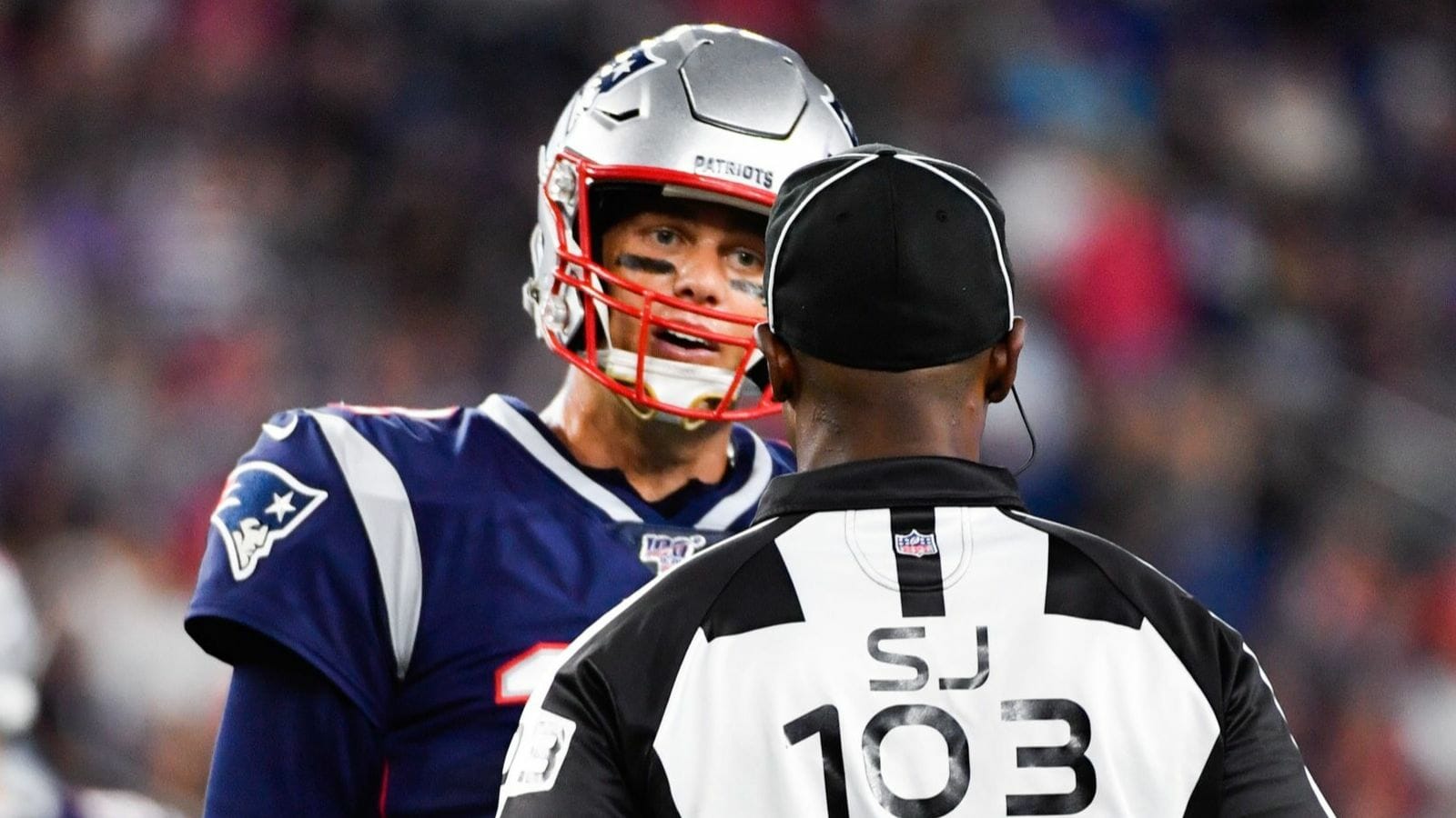 New England Patriots quarterback Tom Brady has a word with side judge Eugene Hall during a preseason game against the Carolina Panthers at Gillette Stadium.