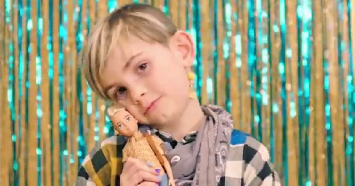 Boy with "gender neutral" doll