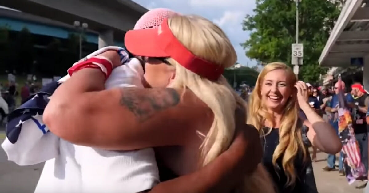 A liberal named Marcus is hugged by a Trump supporter in Cincinnati.