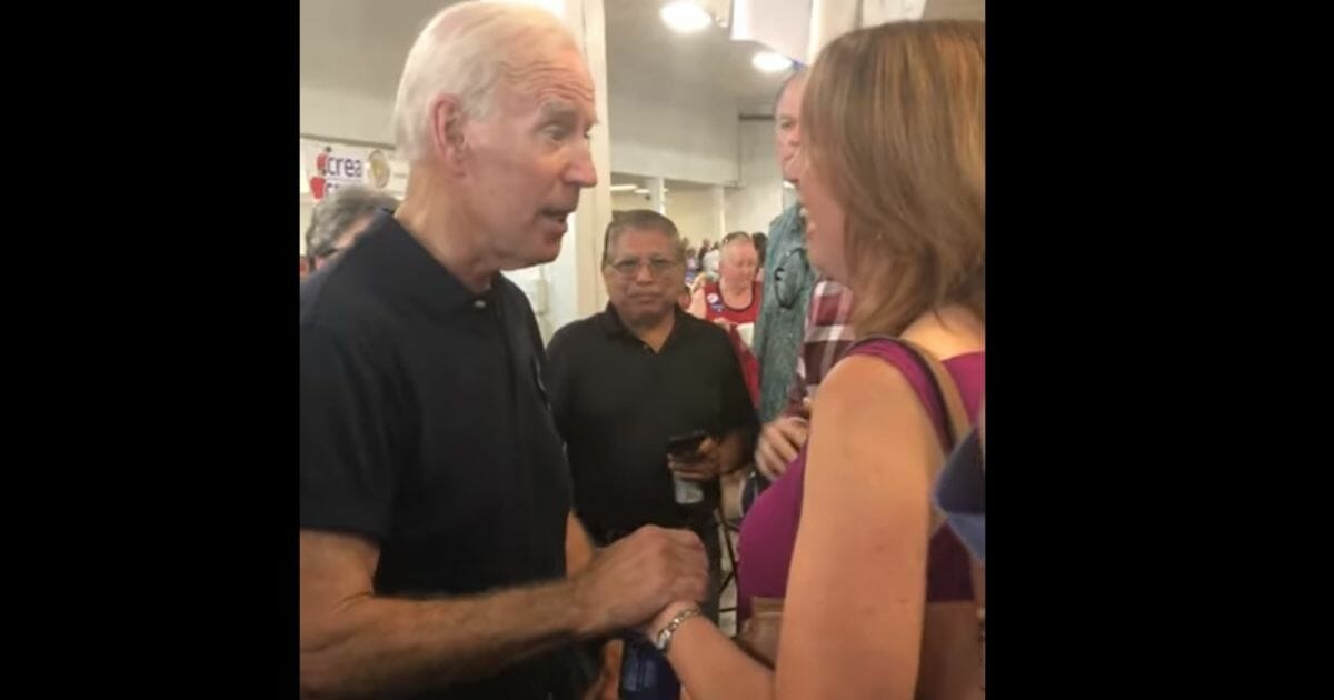 Joe Biden touches a teacher, who later said it was unwanted contact.