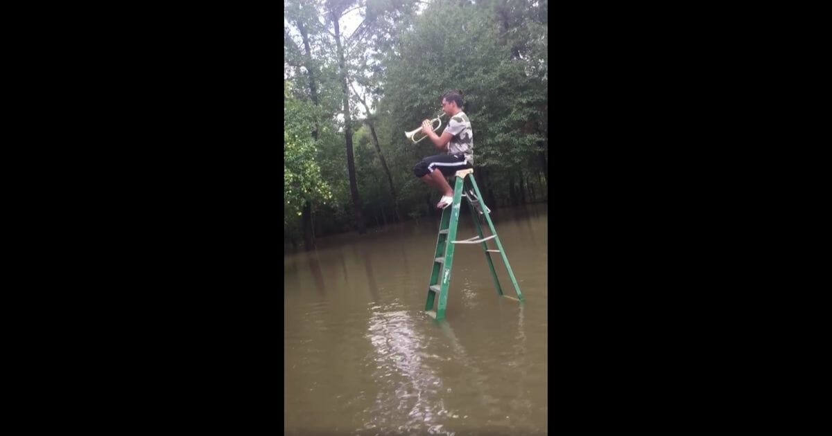 Band director Geovani Ayala responded to the devastation of Tropical Storm Imelda by climbing a ladder and playing Louis Armstrong on his flugelhorn.