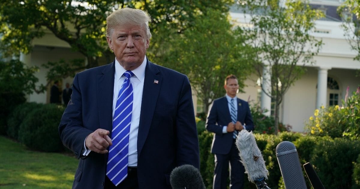 President Donald Trump speaks to members of the media prior to his departure for Camp David from the White House on Friday.