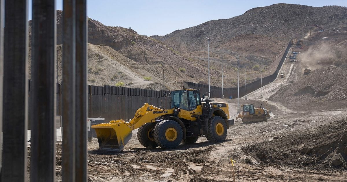 Construction crews work on a border wall being put in place by We Build The Wall Inc. on June 01, 2019 in Sunland Park, New Mexico.
