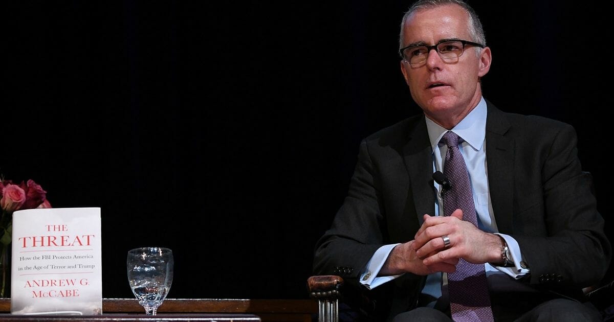 Former FBI Deputy Director Andrew McCabe is pictured on stage with his new book in March at the American Jewish University in Los Angeles.