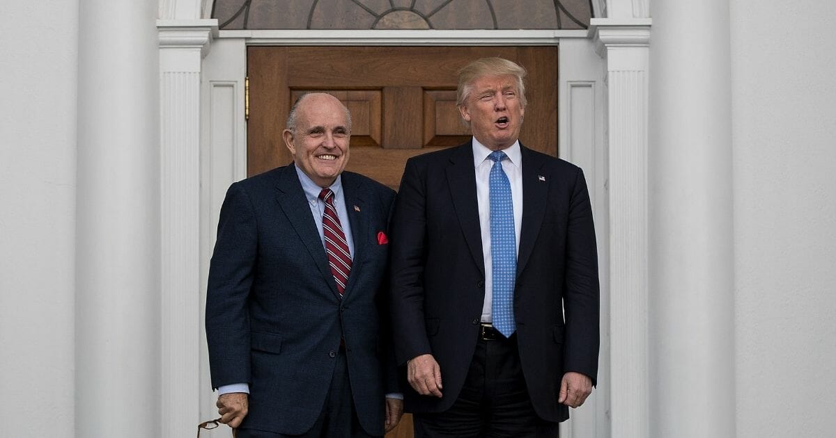 Former New York City mayor Rudy Giuliani stands with then-president-elect Donald Trump before their meeting at Trump International Golf Club, Nov. 20, 2016, in Bedminster Township, New Jersey.