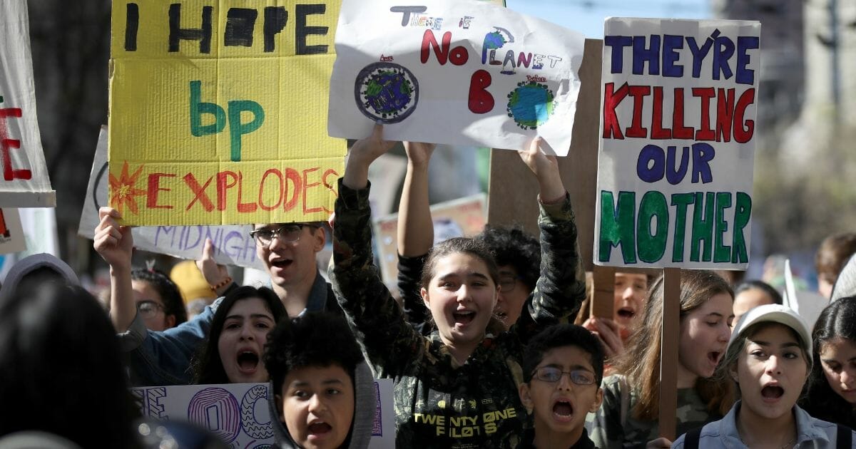 Student activists carry signs as they march during the Youth Climate Strike on March 15, 2019, in San Francisco, California.