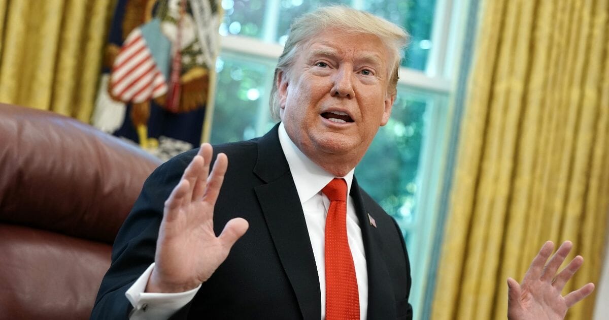 U.S. President Donald Trump talks to reporters following a briefing from officials about Hurricane Dorian in the Oval Office at the White House September 04, 2019.