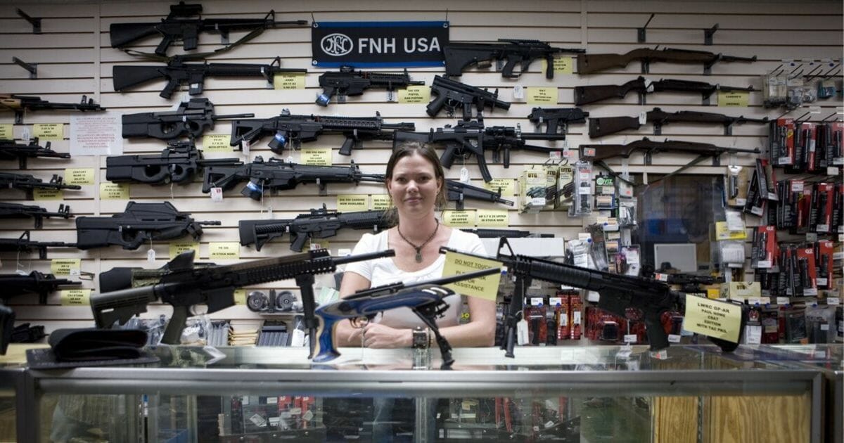 Gina Brewer, the manager of a gun shop in San Antonio, Texas, stands behind the counter at her store on June 17, 2009.