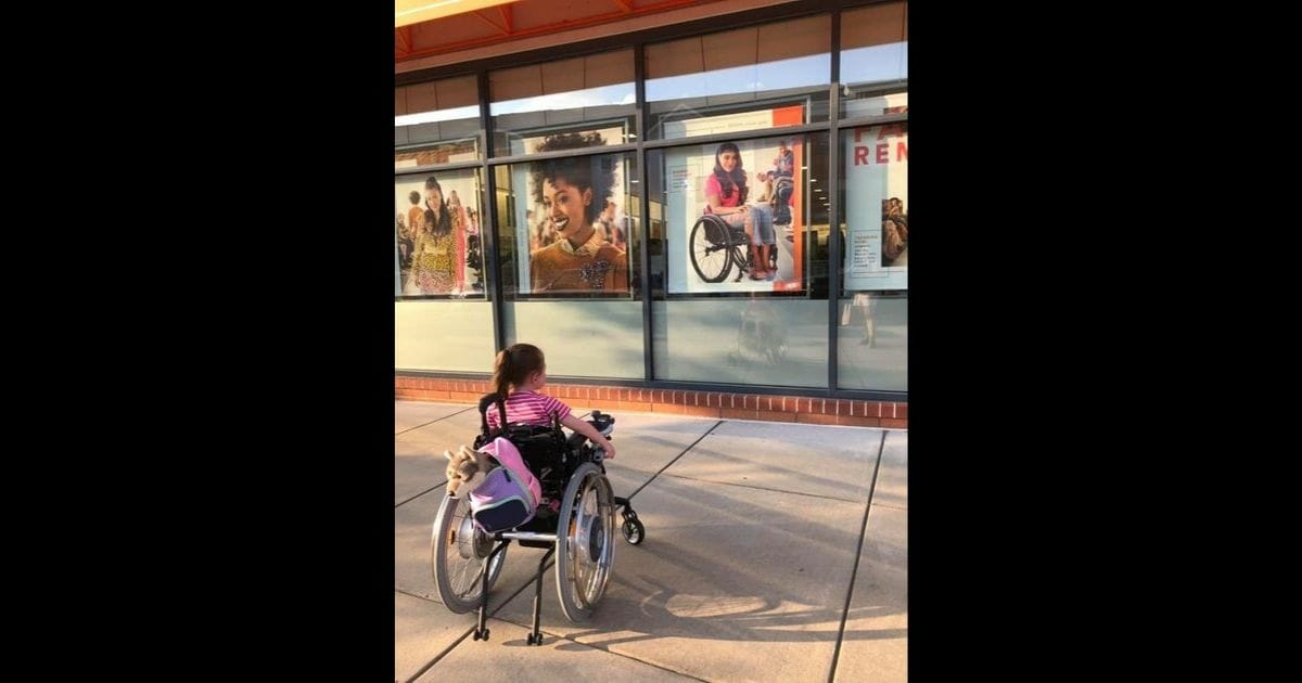 Maren Anderson gazes at a photo of Steph Aiello, a professional model who uses a wheelchair just like her.
