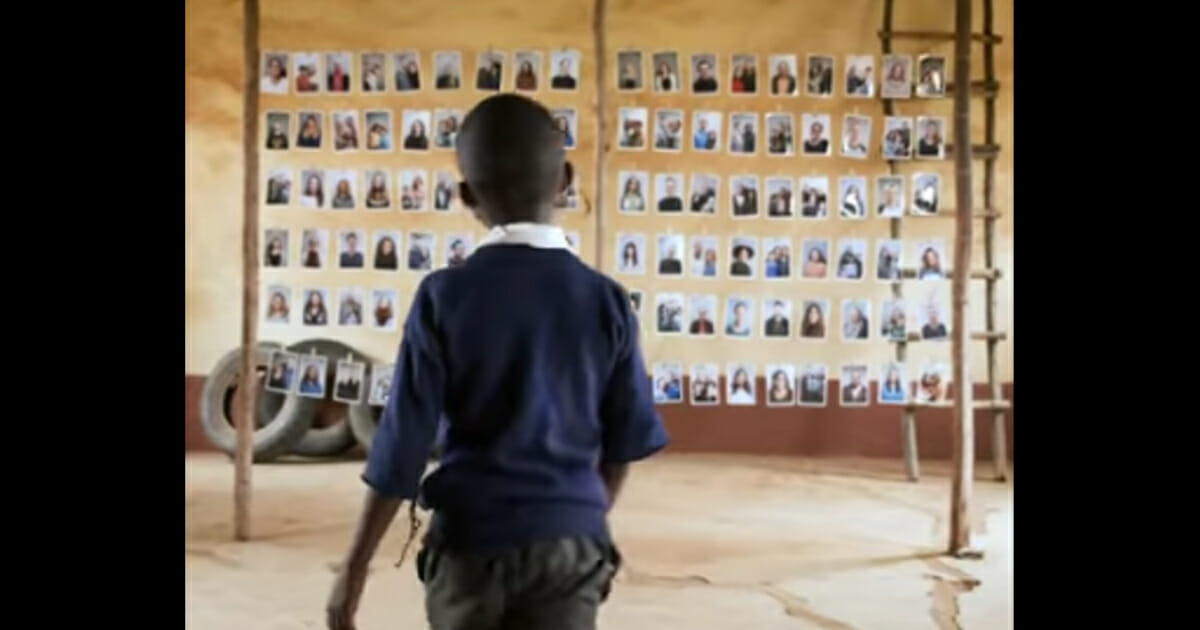 A child looks at photos of potential World Vision sponsors.