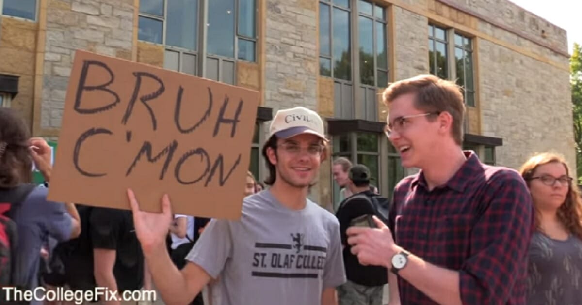 A student at St. Olaf College in Minnesota holds a sign that says "Bruh C',mon" during a climate change protest Sept. 20.