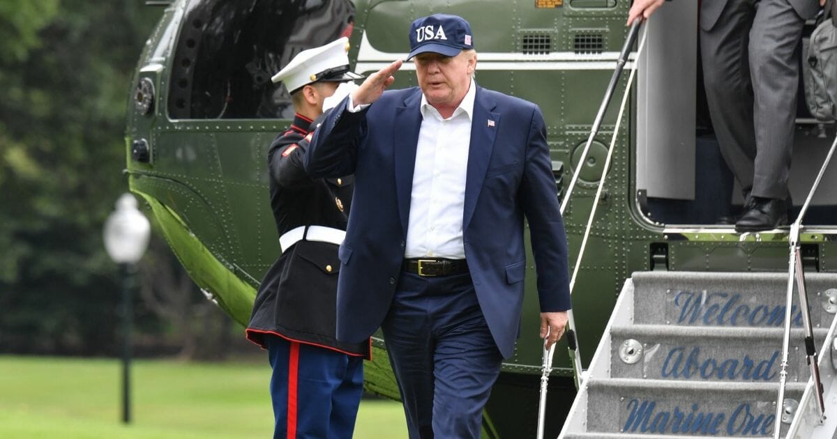 President Donald Trump salutes upon arrival at the White House in Washington, DC, on September 1, 2019 after spending the weekend at the Camp David presidential retreat.