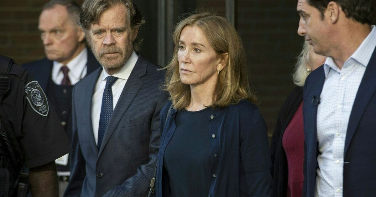 Actress Felicity Huffman, escorted by her husband William H. Macy (L), exits the John Joseph Moakley United States Courthouse in Boston, where she was sentenced by Judge Talwani for her role in the College Admissions scandal on Sept. 13, 2019.