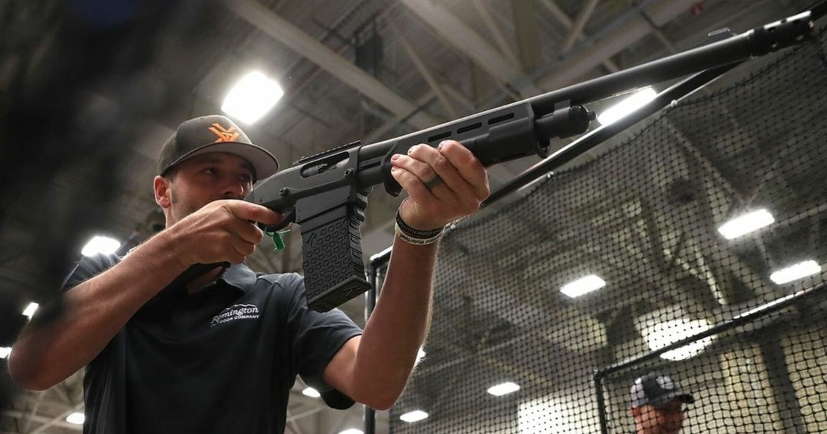 An attendee participates in a gun reloading competition at the Remington booth during the NRA Annual Meeting & Exhibits at the Kay Bailey Hutchison Convention Center.