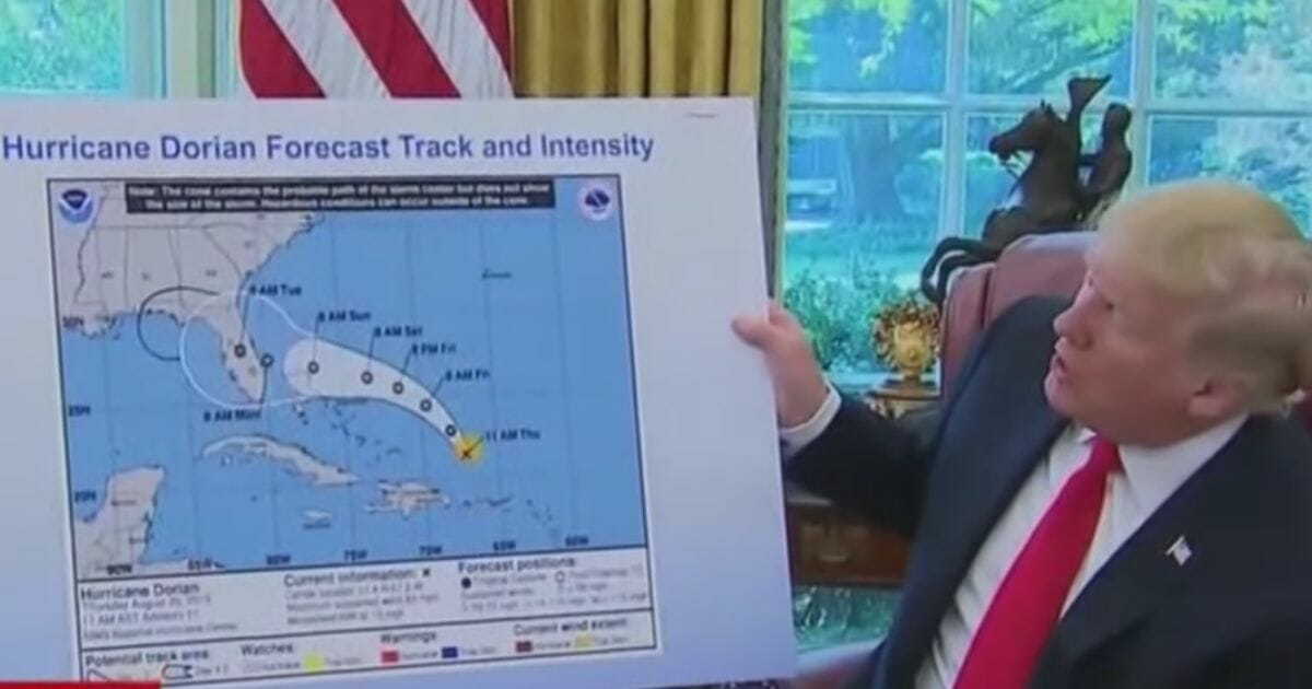 President Trump looks at Hurricane Dorian's storm path on a map.
