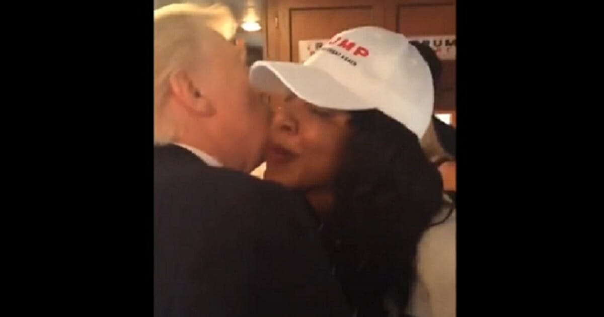 Then-candidate Donald Trump kisses a campaign stafferon the cheeck.