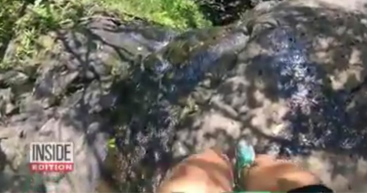 Woman falls down waterfall