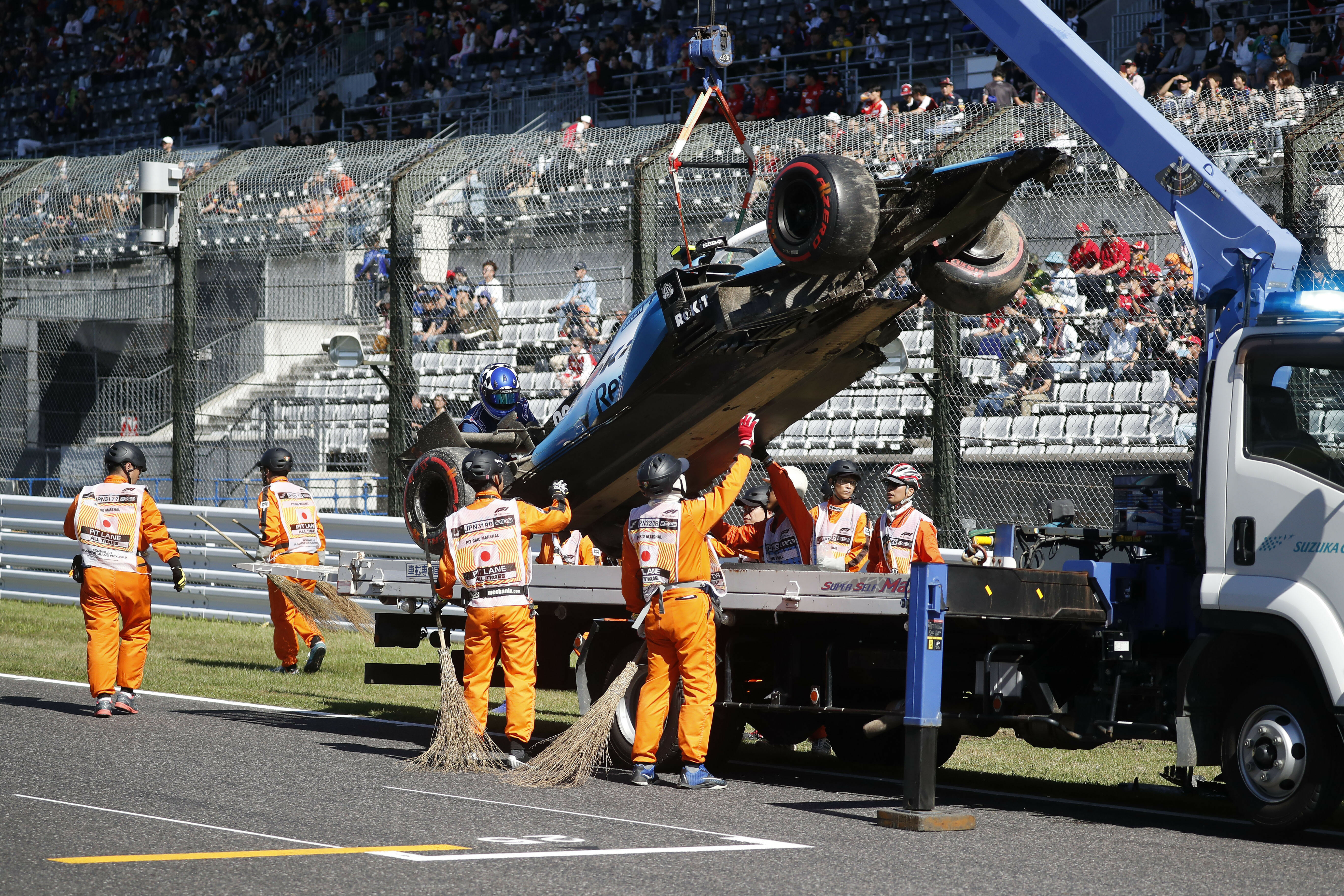 The car of Williams driver Robert Kubica of Poland is removed from the track after crashing during the qualifying session for the Japanese Formula One Grand Prix at Suzuka Circuit in Suzuka, central Japan, Sunday, Oct. 13, 2019.