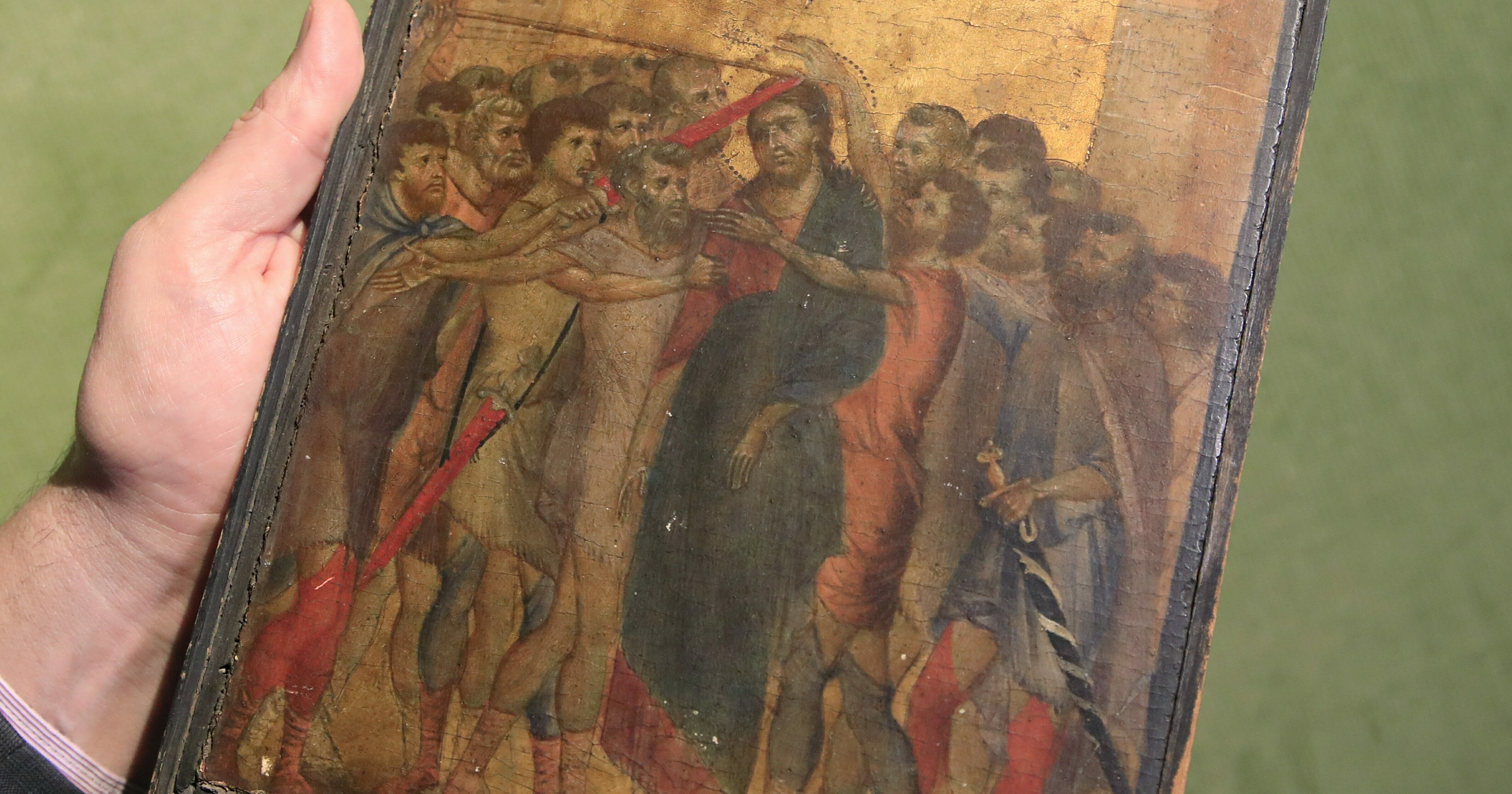 In this Sept. 24, 2019, file photo, art expert Stephane Pinta points to a 13th-century painting by Italian master Cimabue in Paris.