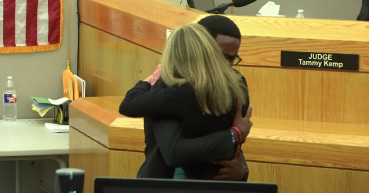 An 18-year-old's act of forgiveness stunned a courtroom this week when the young man embraced and forgave the woman convicted of murdering his brother.