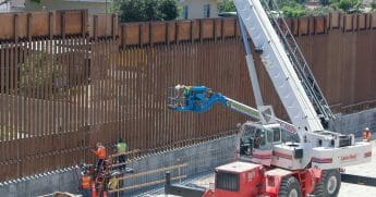 Crews work on a stretch of new border wall in San Ysidro, California.