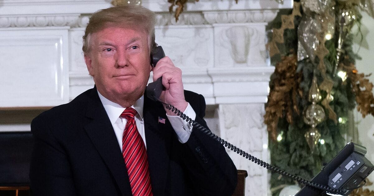 Donald Trump speaks on the telephone.