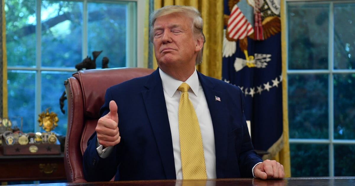 President Donald Trump gestures as he speaks after announcing and initial deal with China while meeting the special Envoy and Vice Premier of the People's Republic of China Liu He at the Oval Office of the White House in Washington, D.C., on Oct. 11, 2019.