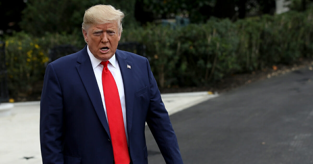 President Donald Trump walks out of the White House to answer questions while departing the White House on Oct. 3, 2019, in Washington, D.C.