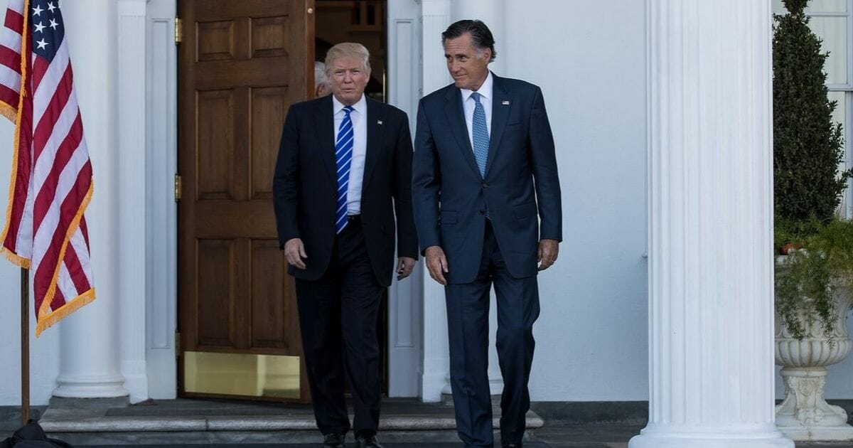 President-elect Donald Trump and Mitt Romney leave the clubhouse after their meeting at Trump International Golf Club, Nov. 19, 2016, in Bedminster Township, New Jersey.