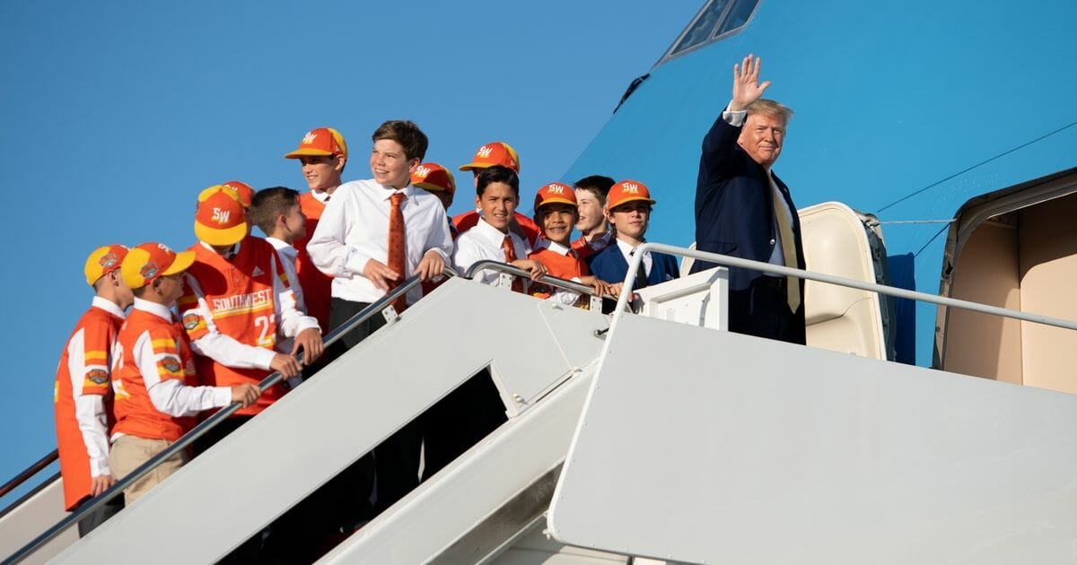 President Donald Trump boards Air Force One with members of the Little League World Championship baseball team, the Eastbank All Stars of Louisiana, prior to departure from Joint Base Andrews in Maryland, Oct. 11, 2019, as he travels to Louisiana, to hold a campaign rally.