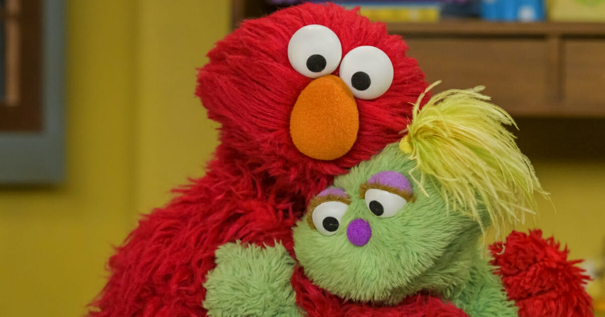Elmo, left, comforts Karli, a relatively new Sesame Street character.