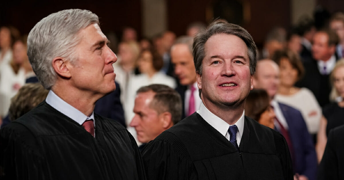 Supreme Court Justices Neil Gorsuch, left, and Brett Kavanaugh attend the State of the Union address at the Capitol.