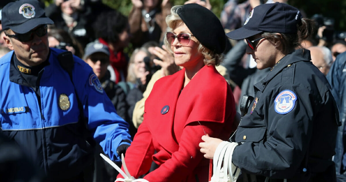 Actress Jane Fonda is arrested for blocking a street in front of the U.S. Capitol during a “Fire Drill Fridays” climate change protest and rally on Capitol Hill on Oct. 18, 2019, in Washington, D.C.