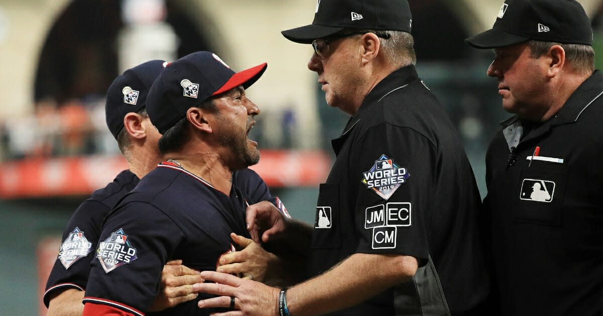 Washington Nationals manager Dave Martinez is held back by bench coach Chip Hale as he argues with umpire Gary Cederstrom in the seventh inning of Game 6 of the World Series against the Houston Astros.